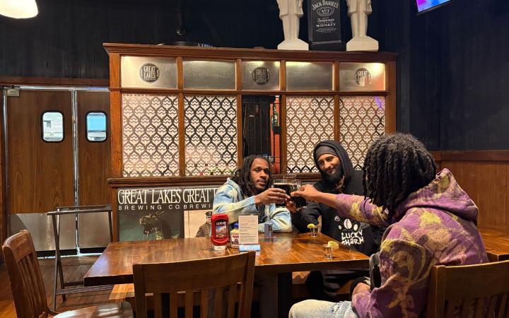 Three patrons enjoy a beer at GLBC, Oct. 28, 2025 (credit: Morgan Alten)