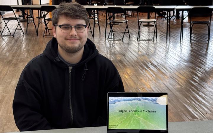 Liame Browne alongside his presentation on algae blooms. (credit: Anthony Reed)
