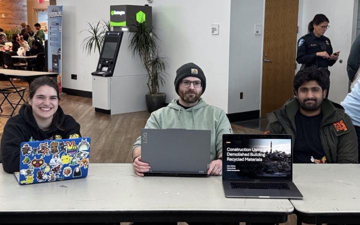 Aidyn Johnson, left, Thomas O’Neill, middle, Hrithik Ramachandra, right, with their project about reusing demolition materials for construction. (credit: Anthony Reed)