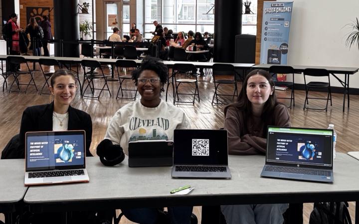 Penelope Tsambounieris, left, Ashia Turney, middle, and Hailey Pischel present their project about the impact of artificial intelligence on the environment. (credit: Anthony Reed)