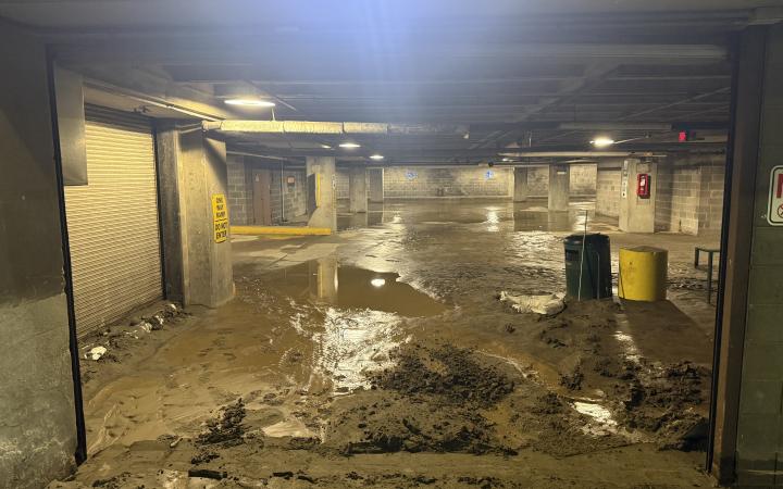  First floor of the main building parking garage covered in water and debris.