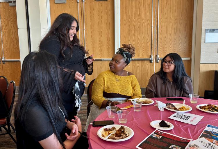Ruby Darwish, a New Era Scholars member, passing out free nail appointment raffle tickets to attendees at the New Era Scholars Women’s Week: “Women United” event in Cleveland State Student Center Ballroom on Oct. 28, 2025.