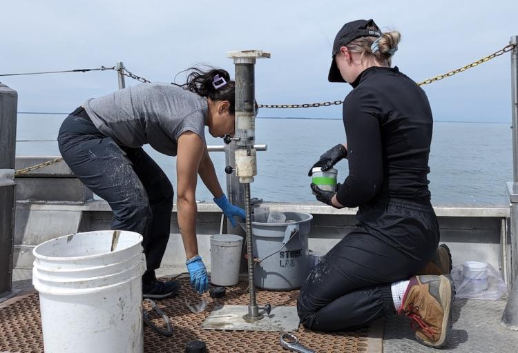 CSU Ph.D. student Anshula Dhiman, left, samples sediments from Lake Erie as part of her investigation into algae.