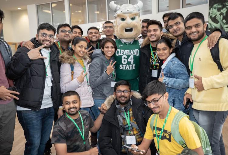 In this file picture from Oct. 18, 2022, international students at Cleveland State University pose with Magnus, CSU's school mascot.