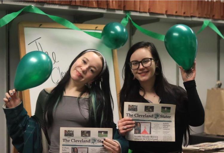 Morgan Alten and Nicole Wlozek-Therens hold copies of the Cleveland Stater while celebrating the newspaper in the Stater newsroom on March 3, 2026.