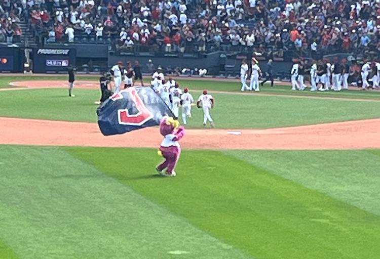 The Guardians' Slider with a flag at Progressive Field.