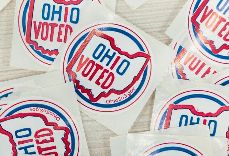 Ohio Voted stickers laid out at a polling location.