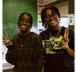 Two students posing at the fall 2023 pride mixer.