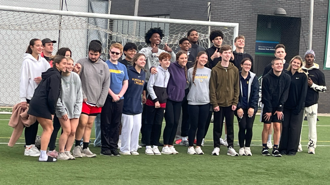 Athletes and volunteers pose after the conclusion of the soccer drill at the Special Olympics, Oct. 7.