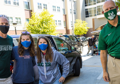 President Harlan Sands (R) practices social distancing on move-in day for the fall semester at Cleveland State University, Aug. 20, 2020.