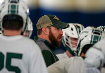 CSU Lacrosse coach Andy German inside the huddle with his team.