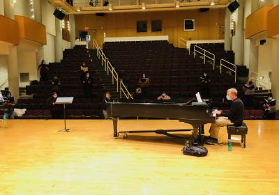 Dr. Brian Bailey playing piano and instructing the Cleveland State University choir.