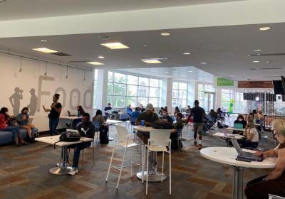 Students sitting in dining area tables in student center