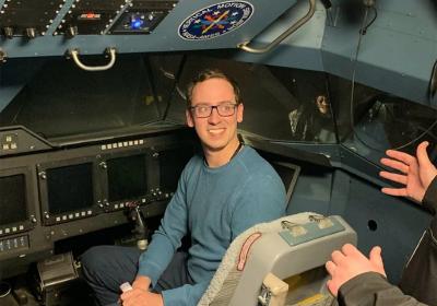 Professor Pedro Gerum, a member of the CSU Department of Operations and Supply Chain Management, sits in the cockpit of a NASA spaceship in 2019.