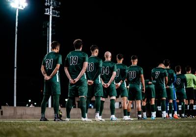 CSU men's soccer team stands for the national anthem. 