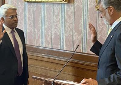 Dr. Nigamanth Sridar, left, being sworn in to serve on CMSD’s school board by former Cleveland Mayor Frank Jackson on July 1, 2021.