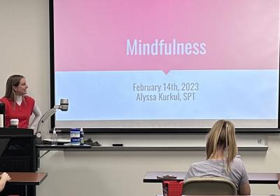 Graduate student Alyssa Kurkul looks at her PowerPoint presentation titled "Mindfulness."