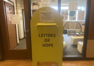 A yellow mailbox outside of CSU's Women's Center with the words "Letters of Hope" written across it.