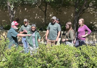 Tim Joseph talks to the group about spirea shrubs.