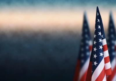 American flags against a blue fog background