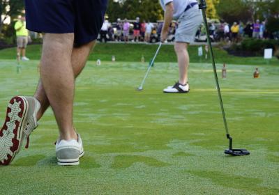 Golfers on the practice putting green at the  CSU "Golf Scramble."