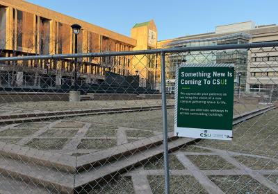 Fence around outdoor plaza as renovations begin.