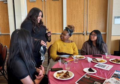  Ruby Darwish, a New Era Scholars member, passing out free nail appointment raffle tickets to attendees at the New Era Scholars Women’s Week: “Women United” event in Cleveland State Student Center Ballroom on Oct. 28, 2025.  