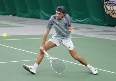 Freshman Tristman Stine goes for a backhand slice at the Vikings Invitational in the Medical Mutual Tennis Center at Cleveland State University on Oct. 26, 2025.   