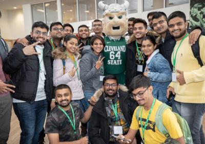 In this file picture from Oct. 18, 2022, international students at Cleveland State University pose with Magnus, CSU's school mascot.