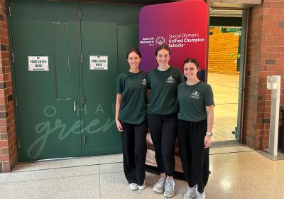 Ashley Browske, center, event organizer, poses alongside fellow occupational therapists Kacie McPeek, right, and Cameron Budzik, left, before welcoming 150 students in for the Special Olympics basketball event on March 27, 2026.