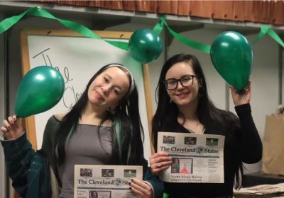 Morgan Alten and Nicole Wlozek-Therens hold copies of the Cleveland Stater while celebrating the newspaper in the Stater newsroom on March 3, 2026.