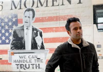 Vivek Ramaswamy, who is running for Ohio governor, standing in front of one of his ads for the 2024 presidential primary campaign. 