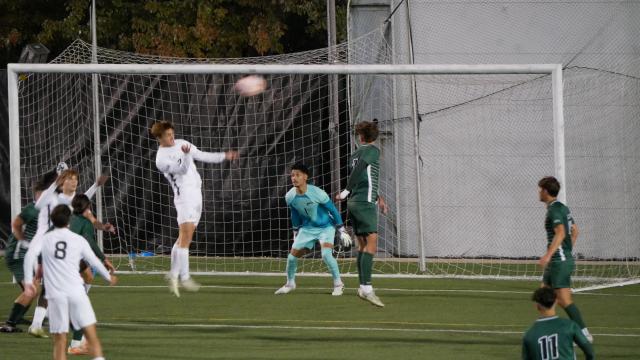 Cleveland State goal keeper stands ready to save a header by Akron.