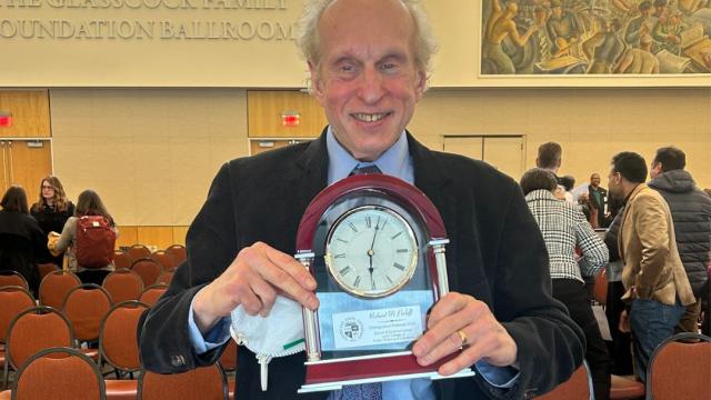 Dr. Richard Perloff poses with his Distinguished Professor award. 