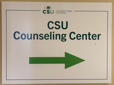 A sign directs visitors to the Cleveland State University Counseling Center inside a campus building. (credit: Aria Ruiz)