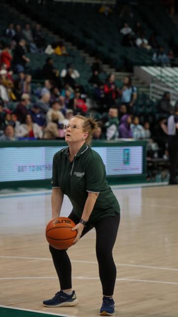 Dean Jill Gordon eyes the basketball hoop and prepares to shoot, Feb. 12, 2025.