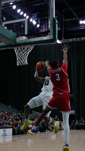  Tevin Smith (0) attempts to score while Robert Morris’ Amarion Dickerson (3) tries to block, at CSU's Wolstein Center, Feb.12, 2025.