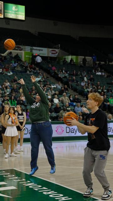 Monte Ahuja College of Business Dean Melissa Gruys, left, takes a shot next to her student counterpart, Feb. 12, 2025.